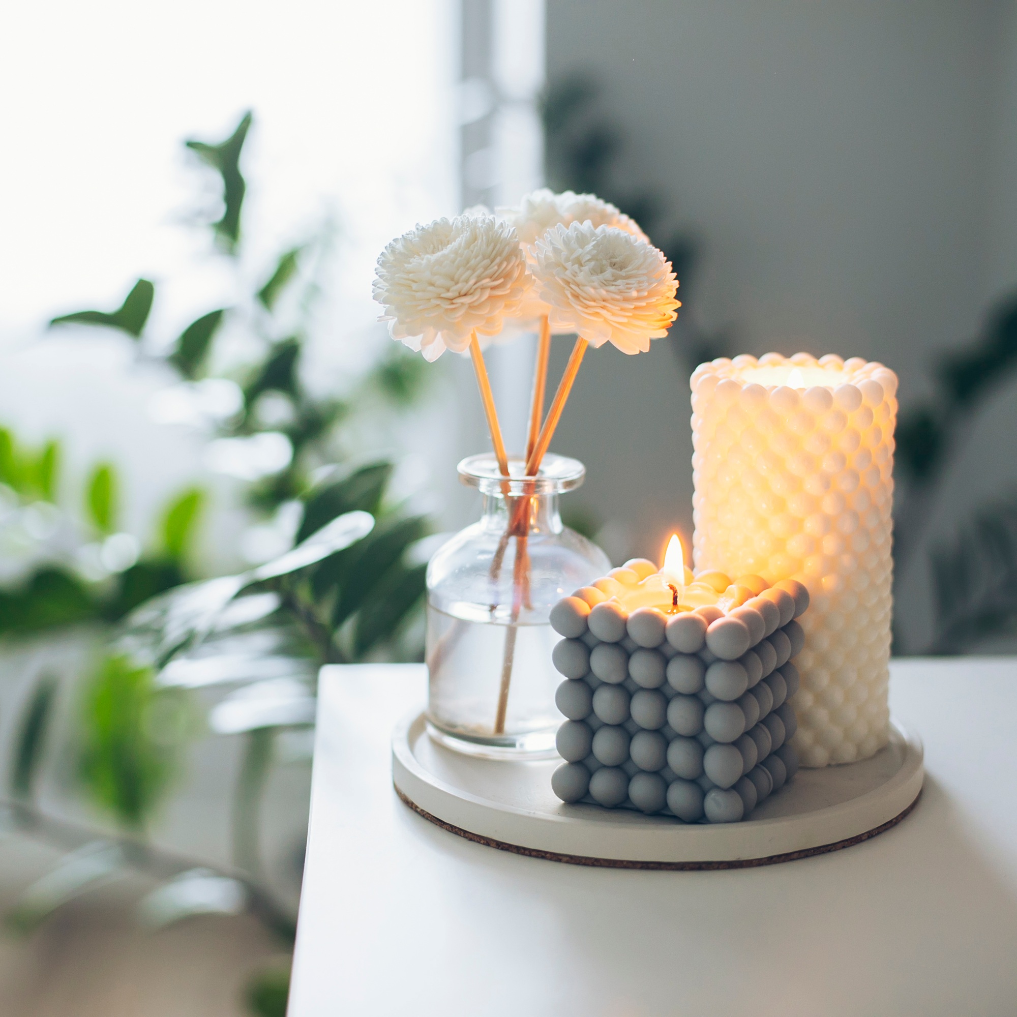 Two trendy burning candle, aroma fragrance diffuser on table. Wellness. Banner image for design